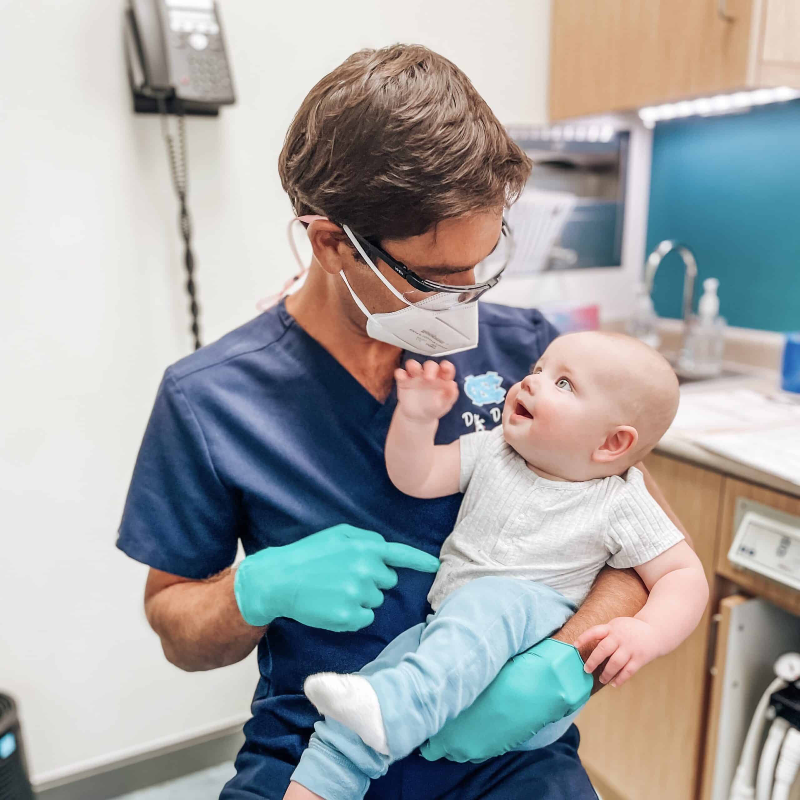 Dr. Kornstein holding little baby