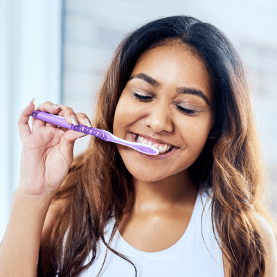 Orthodontics and overall oral health 6 Woman brushing her teeth for oral health